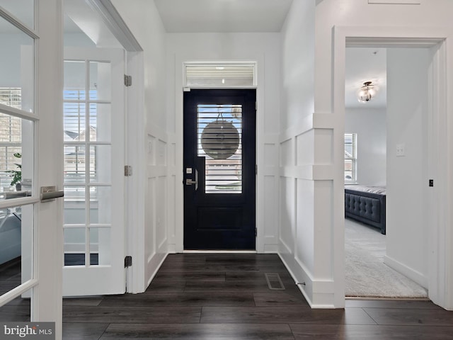 9929 Pesade Way, Upper Marlboro, MD 20772 - foyer featuring dark wood finished floors, a decorative wall, healthy amount of natural light, and a wainscoted wall