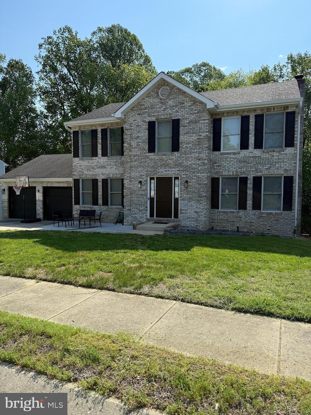 102 Haldane Dr, La Plata, MD 20646 - colonial house with an attached garage, a front yard, and driveway