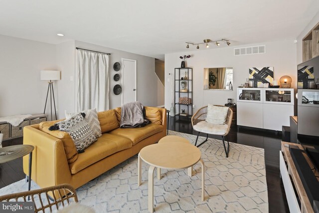 living area with recessed lighting, wood finished floors, and visible vents