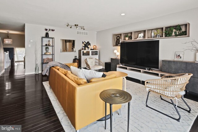 living area featuring recessed lighting, visible vents, and wood finished floors