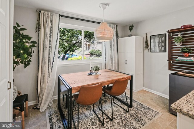 dining area with light tile patterned floors and baseboards