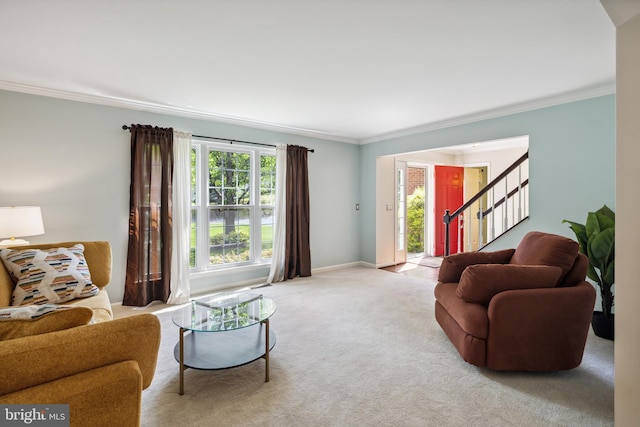 carpeted living room with stairway, baseboards, and ornamental molding