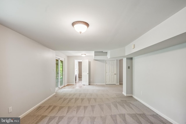 empty room with baseboards and light colored carpet