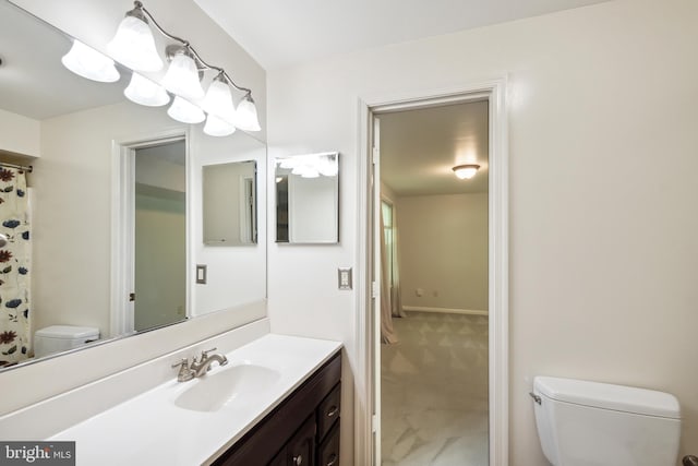 full bath featuring vanity and toilet