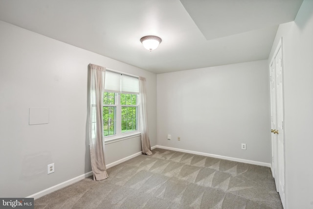 unfurnished room featuring baseboards and carpet