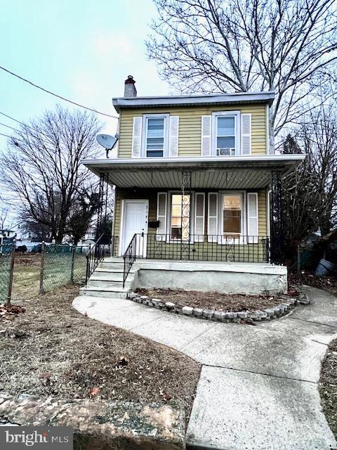 218 Cooper St, Beverly, NJ 08010 - view of front of home featuring a porch, fence, and a chimney