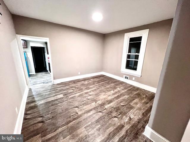218 Cooper St, Beverly, NJ 08010 - spare room featuring baseboards and wood finished floors
