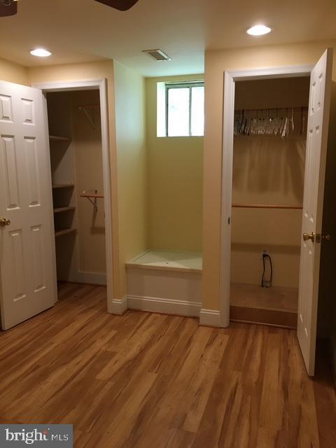 13211 Lutes Dr, Silver Spring, MD 20906 - bathroom featuring wood finished floors, a walk in closet, recessed lighting, and baseboards