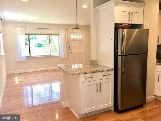 13211 Lutes Dr, Silver Spring, MD 20906 - kitchen featuring freestanding refrigerator, white cabinetry, light wood-style flooring, light stone countertops, and recessed lighting