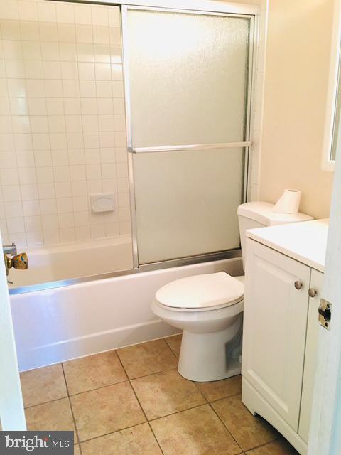 13211 Lutes Dr, Silver Spring, MD 20906 - full bath with toilet, vanity, tile patterned floors, and enclosed tub / shower combo