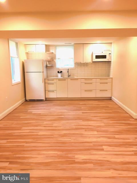 13211 Lutes Dr, Silver Spring, MD 20906 - kitchen with white appliances, baseboards, and light wood-style floors