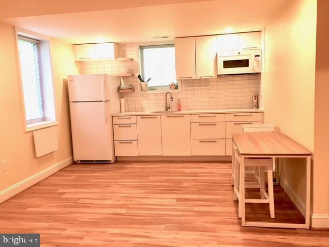13211 Lutes Dr, Silver Spring, MD 20906 - kitchen featuring white appliances, a sink, baseboards, and light wood finished floors