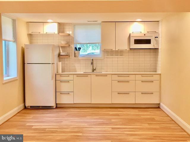 13211 Lutes Dr, Silver Spring, MD 20906 - kitchen featuring white appliances, a sink, baseboards, and backsplash