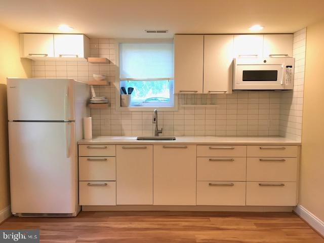 13211 Lutes Dr, Silver Spring, MD 20906 - kitchen featuring white appliances, a sink, light wood-type flooring, light countertops, and recessed lighting