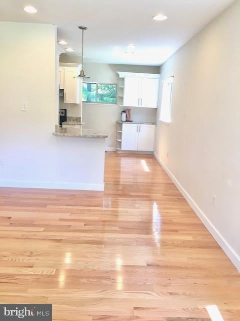 13211 Lutes Dr, Silver Spring, MD 20906 - kitchen with white cabinets, light wood-style floors, baseboards, recessed lighting, and open shelves