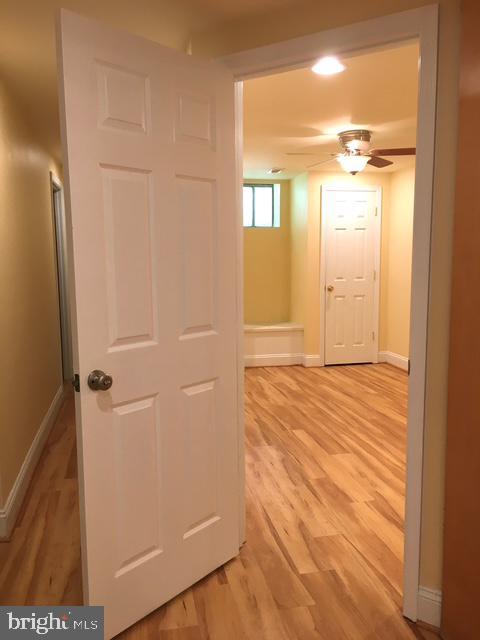 13211 Lutes Dr, Silver Spring, MD 20906 - hallway featuring light wood finished floors and baseboards
