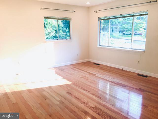 13211 Lutes Dr, Silver Spring, MD 20906 - spare room with plenty of natural light, wood finished floors, and baseboards