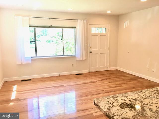 13211 Lutes Dr, Silver Spring, MD 20906 - entryway with healthy amount of natural light, wood finished floors, baseboards, and recessed lighting