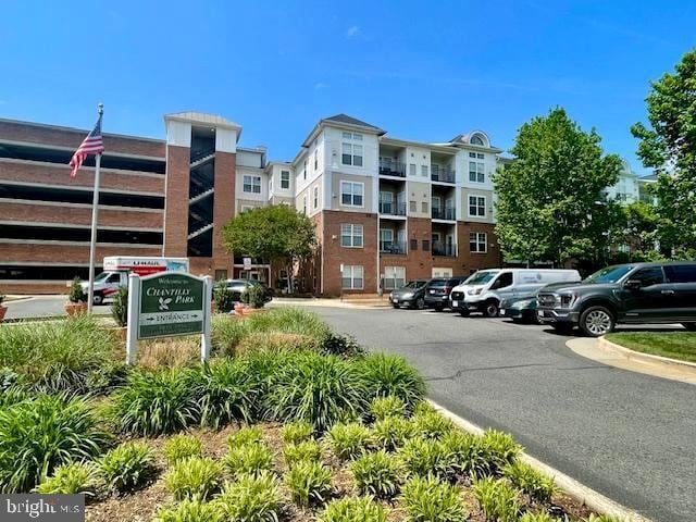 view of building exterior with uncovered parking
