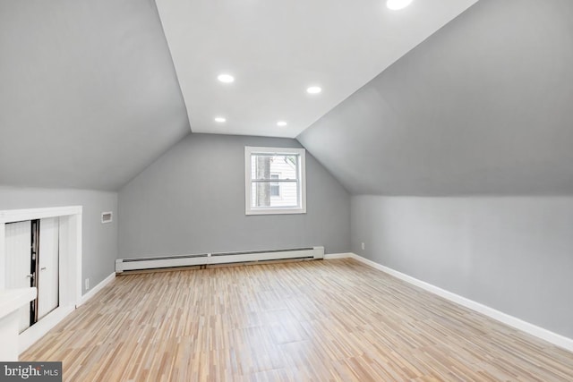 909 Old Lancaster Rd, Berwyn, PA 19312 - additional living space with baseboard heating, light wood-style floors, baseboards, vaulted ceiling, and recessed lighting