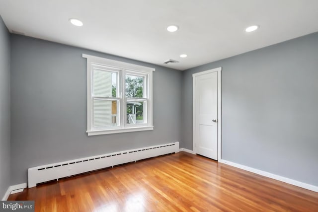 909 Old Lancaster Rd, Berwyn, PA 19312 - empty room featuring a baseboard radiator, recessed lighting, light wood finished floors, and baseboards