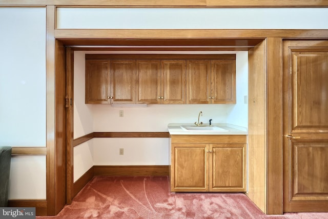 174 Springhouse Ln, Spring Grove, PA 17362 - kitchen with a sink, light carpet, baseboards, light countertops, and brown cabinets