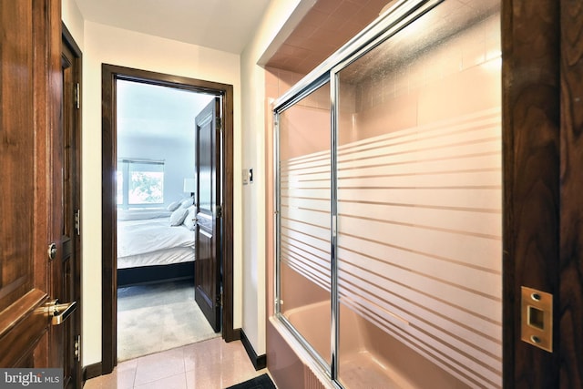 174 Springhouse Ln, Spring Grove, PA 17362 - ensuite bathroom featuring enclosed tub / shower combo, tile patterned flooring, and baseboards