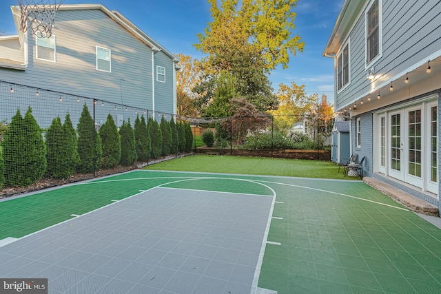 view of basketball court featuring a fenced backyard and basketball court