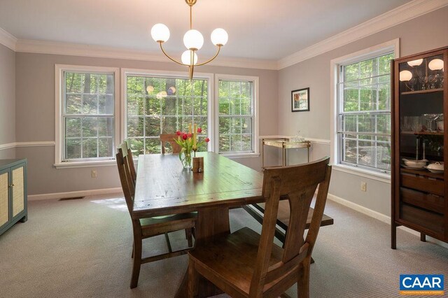 dining space featuring baseboards, ornamental molding, and carpet