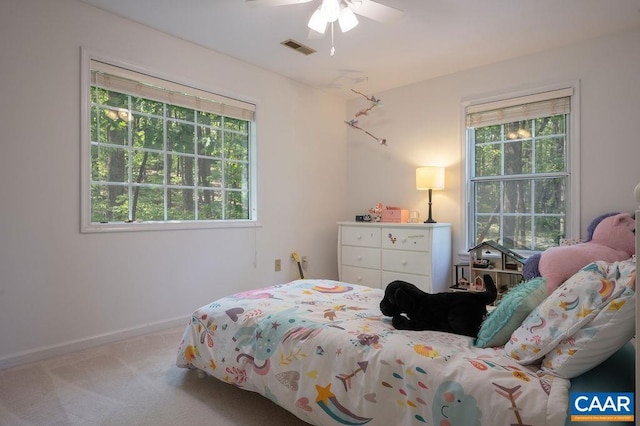 carpeted bedroom with baseboards, ceiling fan, and visible vents
