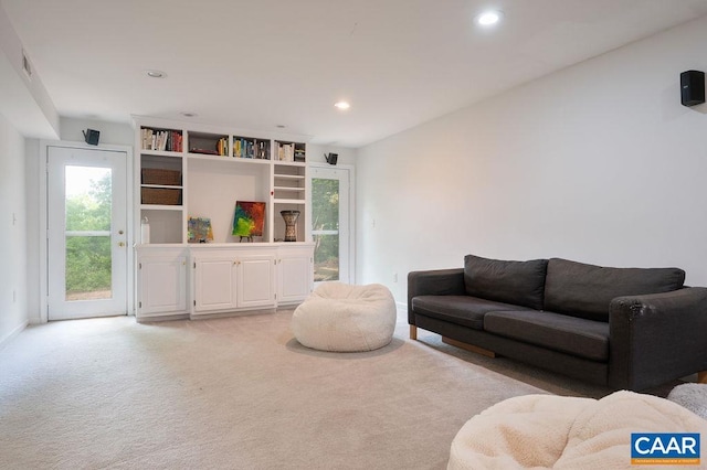 living room with light colored carpet, recessed lighting, baseboards, and visible vents