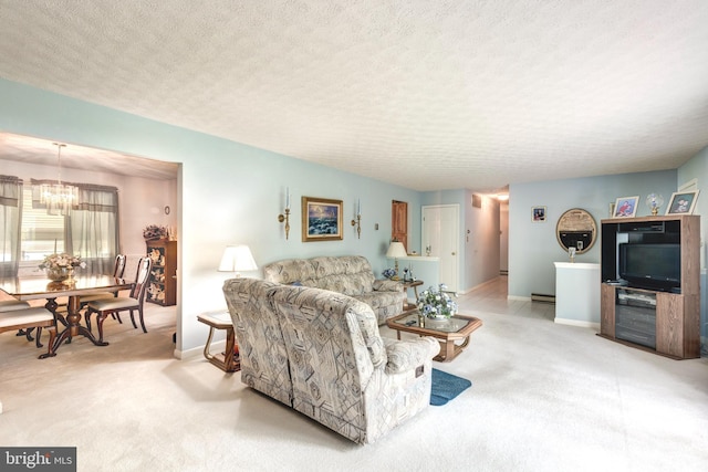 living room featuring baseboards, a textured ceiling, a chandelier, and light carpet