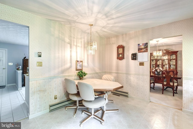 dining room featuring a notable chandelier, wainscoting, wallpapered walls, a baseboard radiator, and a baseboard heating unit