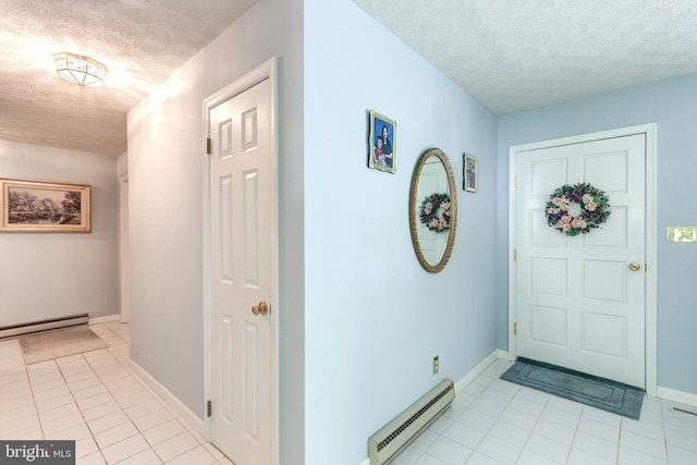 foyer entrance featuring a textured ceiling, baseboard heating, light tile patterned floors, baseboards, and a baseboard heating unit