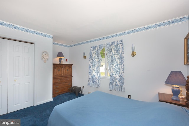 bedroom featuring dark colored carpet, baseboards, and a closet