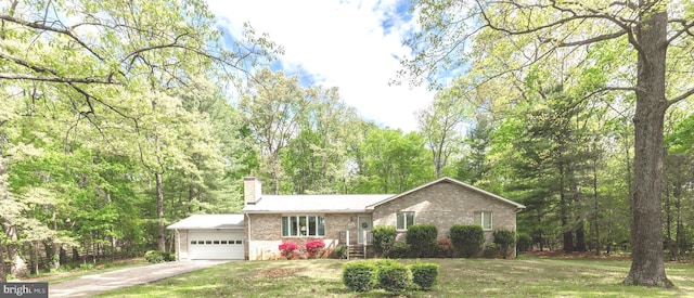 ranch-style home with a chimney, brick siding, a front lawn, concrete driveway, and an attached garage