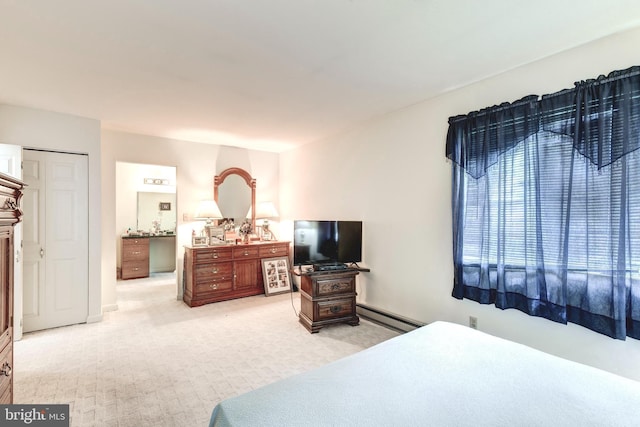 bedroom with a baseboard radiator and light carpet