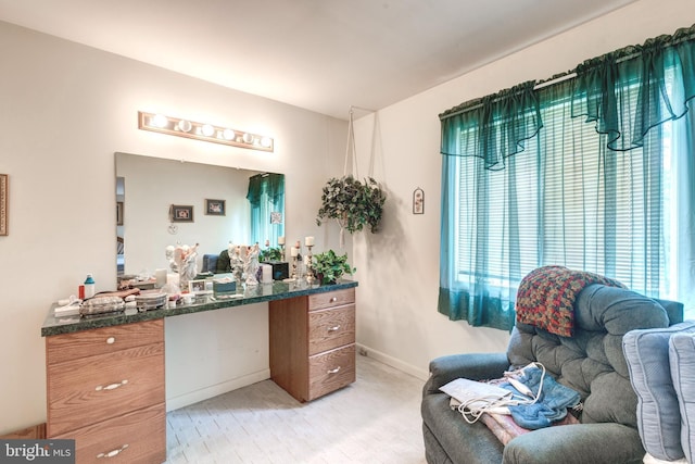 interior space featuring baseboards, a wealth of natural light, and light wood-style floors