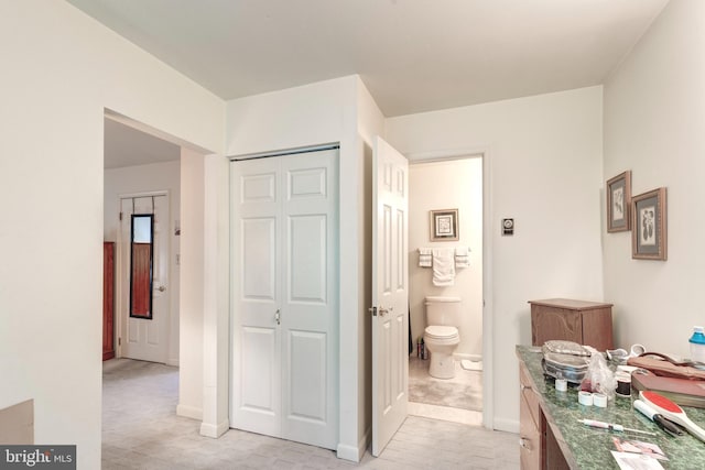 bathroom featuring baseboards and toilet