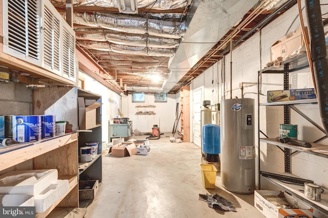 unfinished basement featuring electric water heater