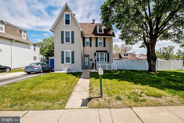 640 Mohawk Ave, Norwood, PA 19074 - traditional-style home with fence, a chimney, and a front lawn