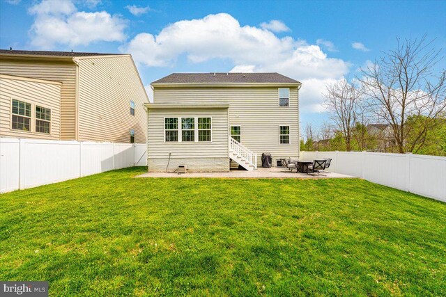rear view of house featuring a fenced backyard, a patio area, and a yard