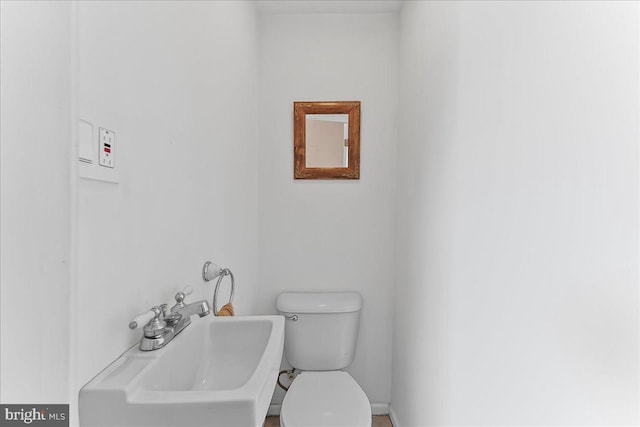 half bathroom with a sink and toilet