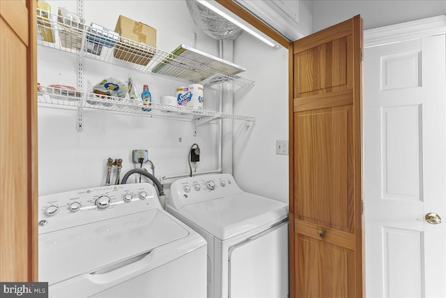 clothes washing area featuring laundry area and washer and clothes dryer