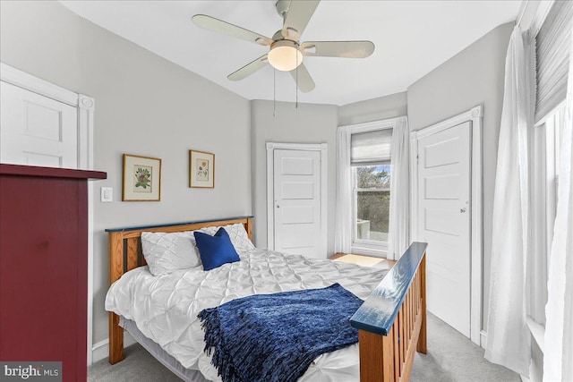 bedroom with light colored carpet, baseboards, and ceiling fan