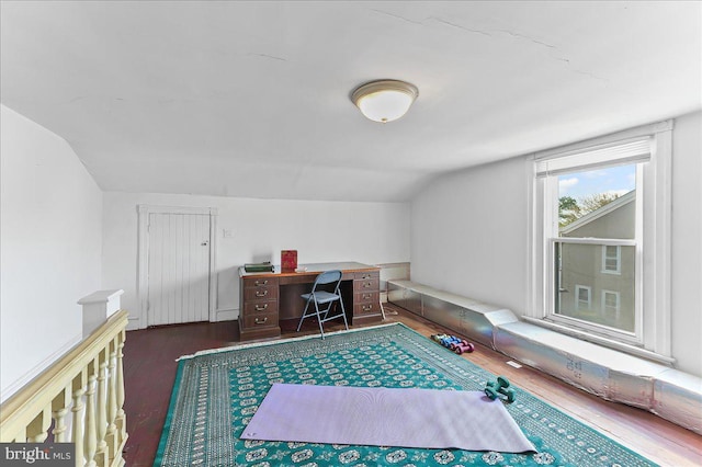 office space with wood finished floors and vaulted ceiling