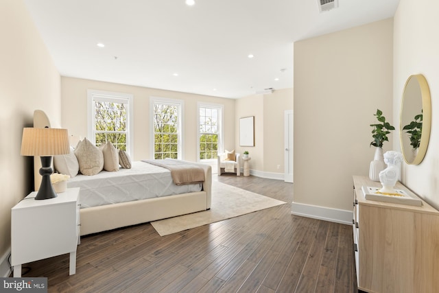 bedroom with visible vents, recessed lighting, dark wood finished floors, and baseboards