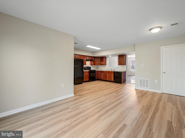 119 Checko Ct, Martinsburg, WV 25401 - kitchen with visible vents, light countertops, black appliances, and light wood-type flooring