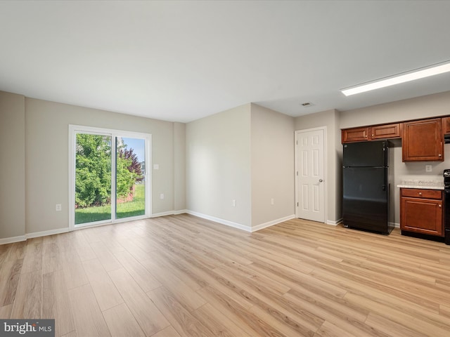119 Checko Ct, Martinsburg, WV 25401 - unfurnished living room with baseboards, light wood-type flooring, and visible vents