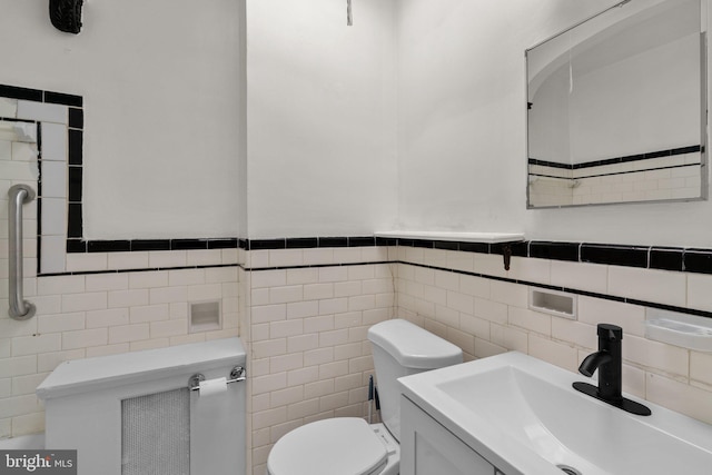 4208 Sheldon Ave, Baltimore, MD 21206 - bathroom featuring tile walls, toilet, vanity, and a wainscoted wall